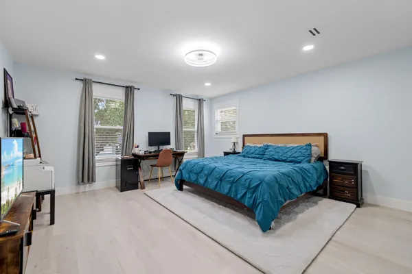 a bedroom with a bed and furniture with window