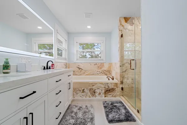 a bathroom with a bathtub and a window