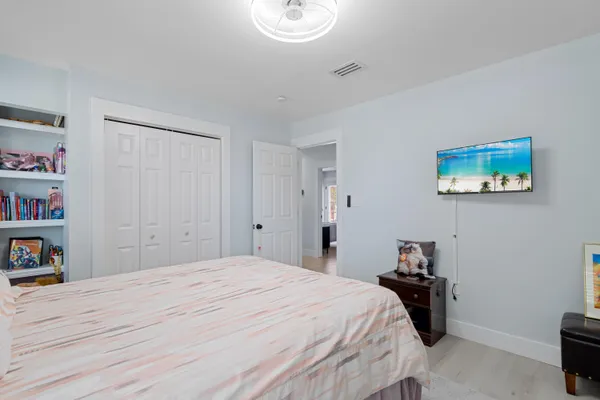 a bedroom with a bed and a painting on the wall