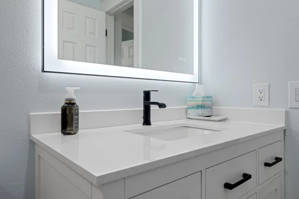 a bathroom with a sink and a mirror
