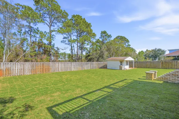 a view of a balcony with wooden floor and fence