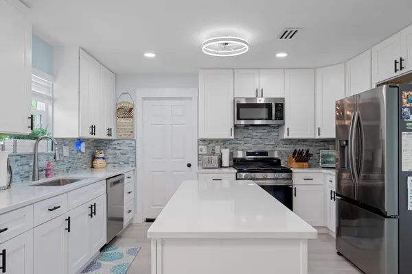 a kitchen with a sink stove and refrigerator