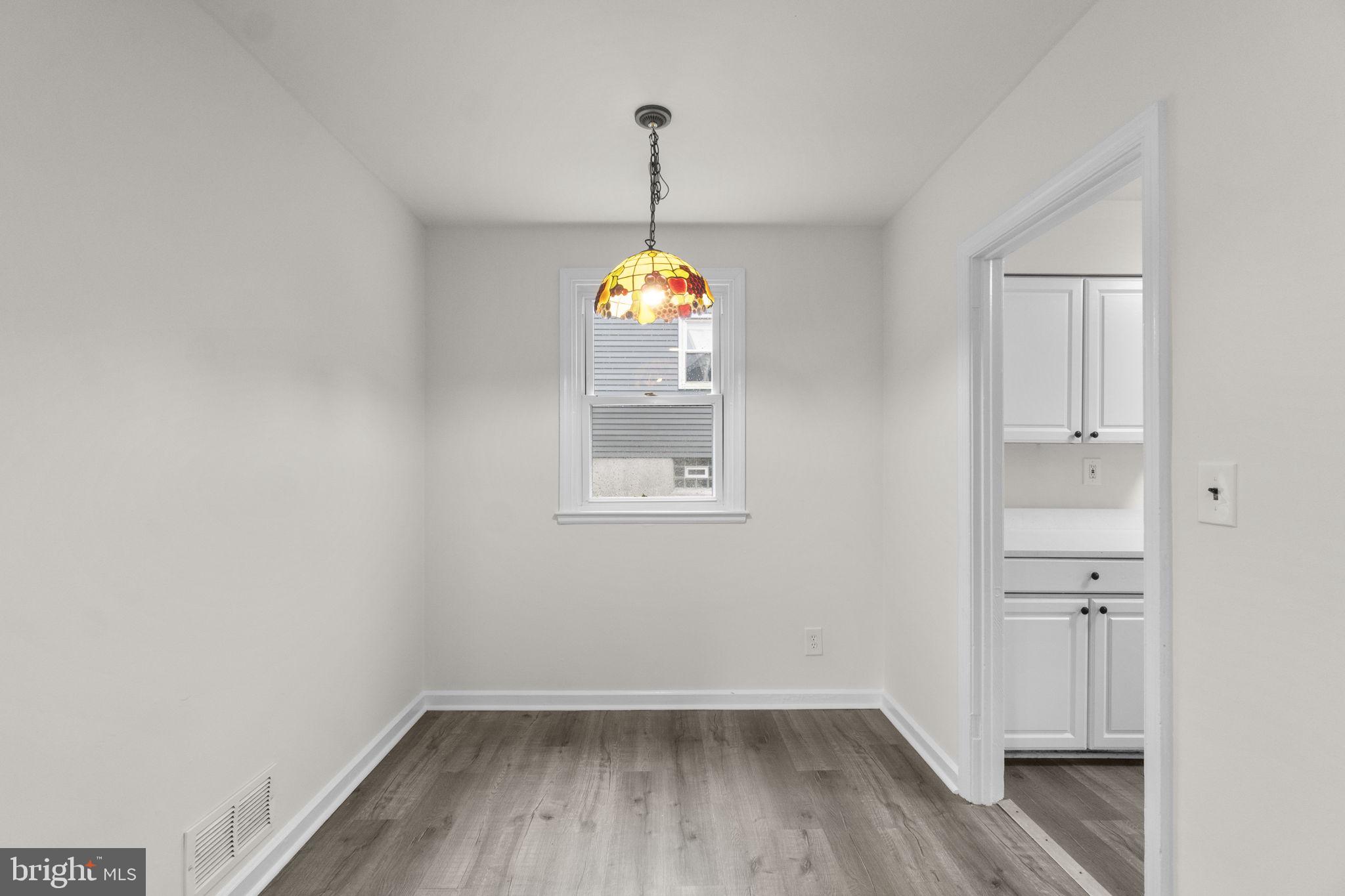 3658 Clifmar Road Baltimore, MD 21244 - Photo 5 of 43 a room that has a window and wooden floor