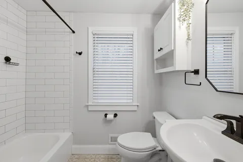 a bathroom with a sink a toilet and bathtub