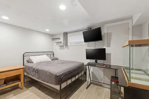 a bedroom with a bed and a flat screen tv