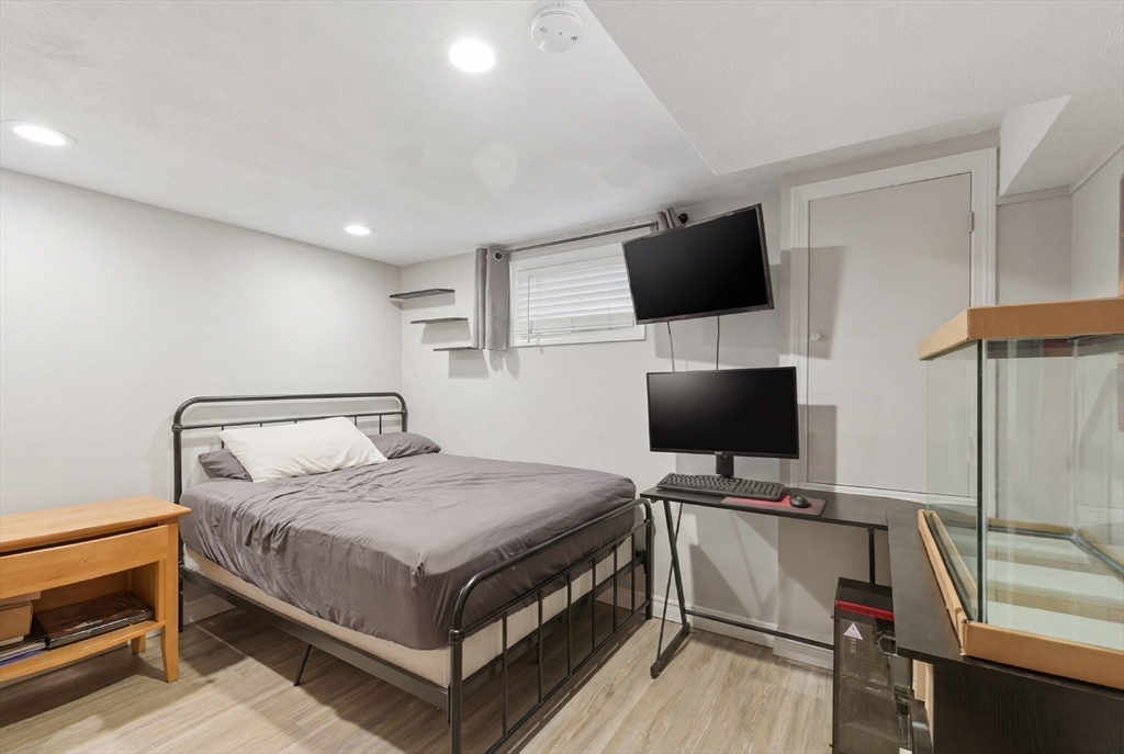 7 Paulette Drive Danvers, MA 01923 - Photo 16 of 25 a bedroom with a bed and a flat screen tv