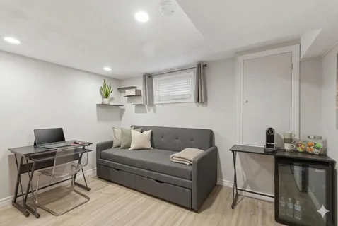 a living room with furniture and a wooden floor