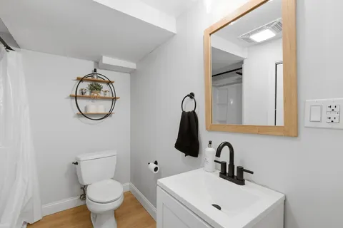 a bathroom with a toilet sink and mirror