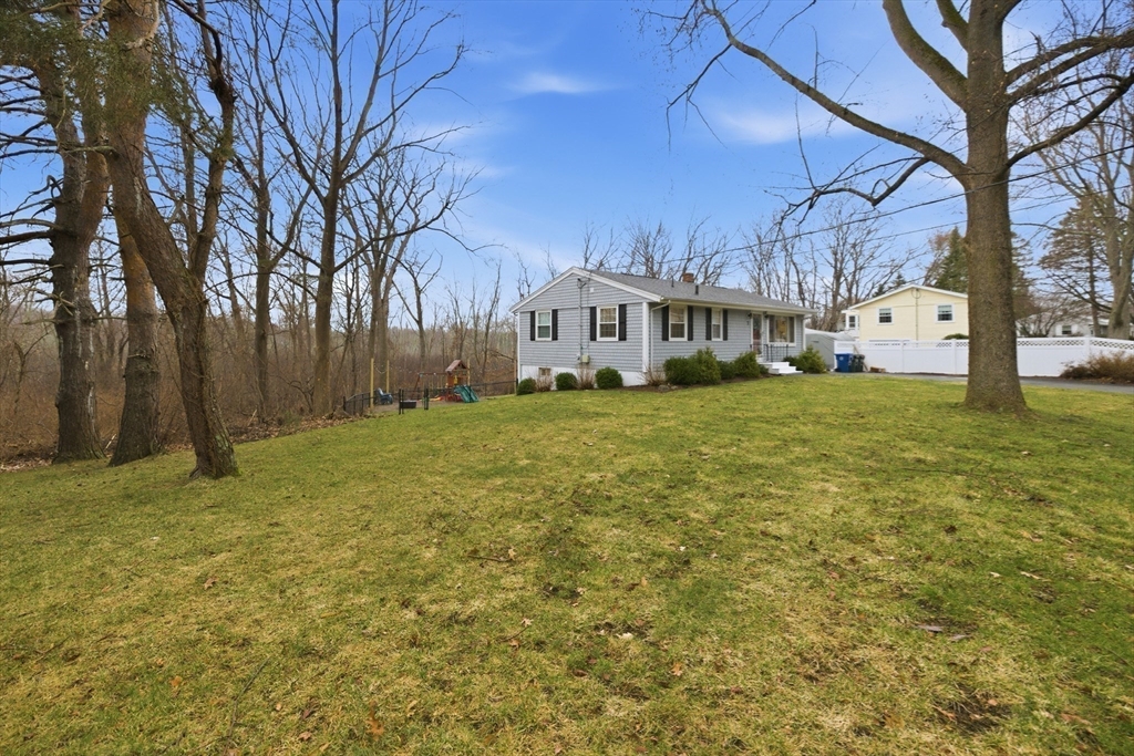 7 Paulette Drive Danvers, MA 01923 - Photo 3 of 25 a view of a yard with a house in the background