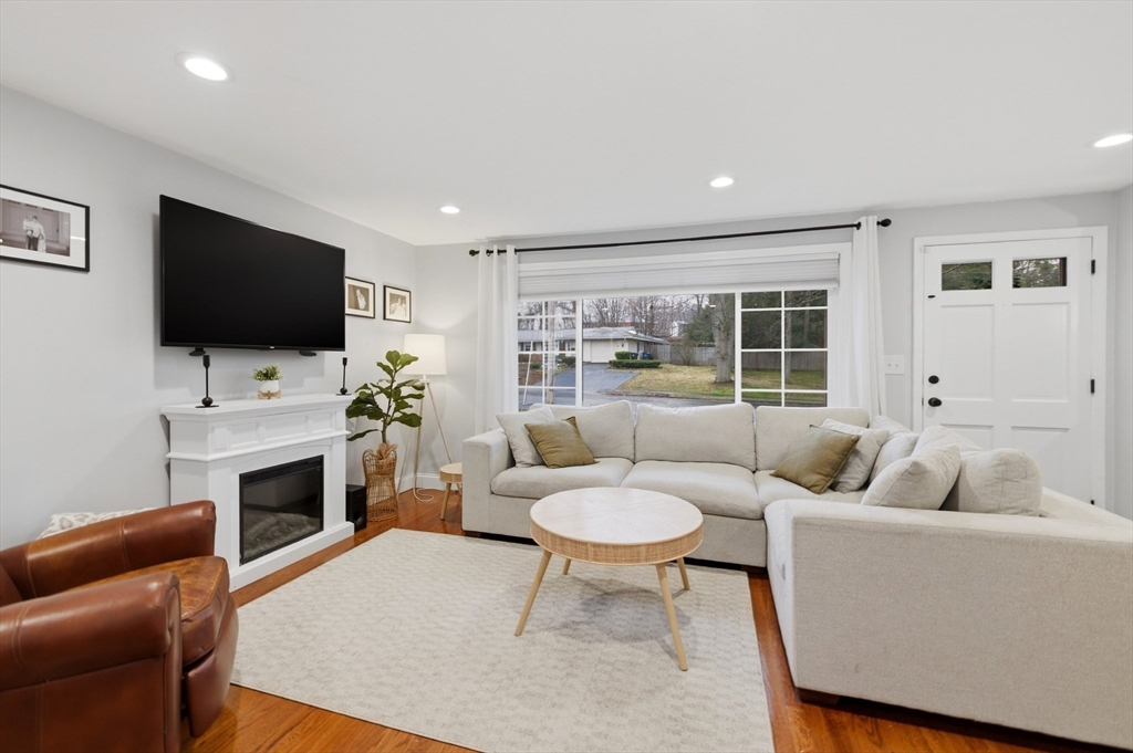 7 Paulette Drive Danvers, MA 01923 - Photo 5 of 25 a living room with furniture a fireplace and a flat screen tv