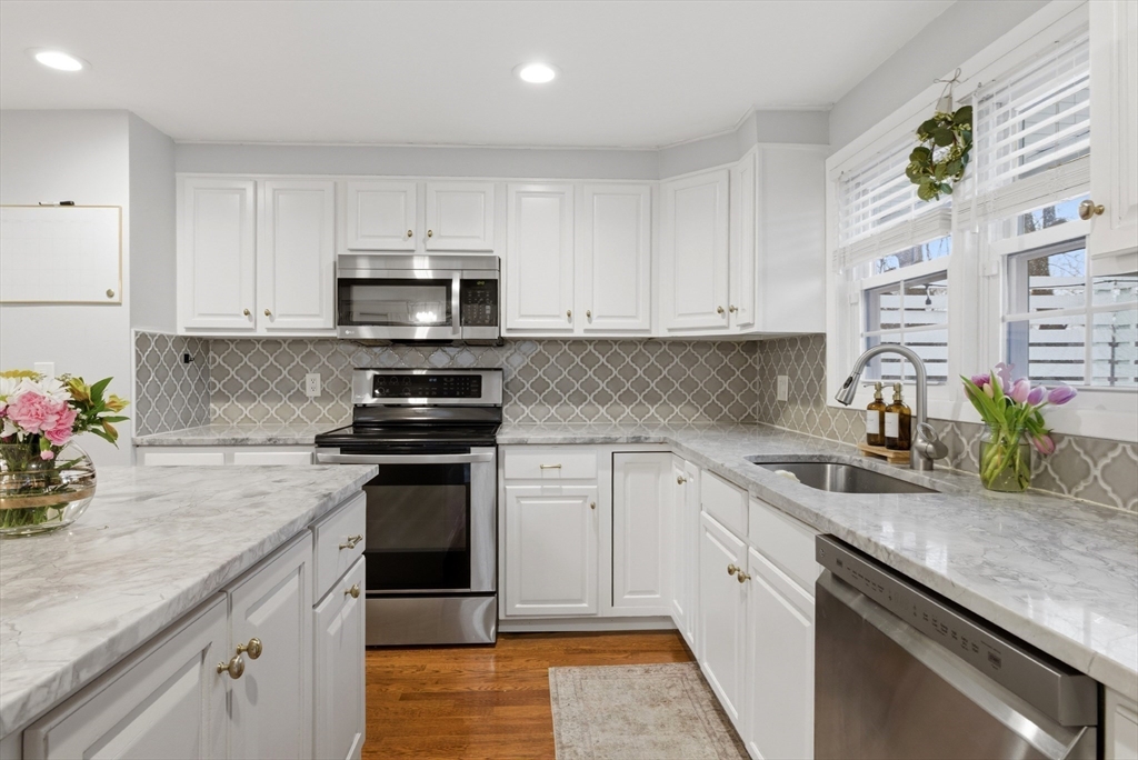 7 Paulette Drive Danvers, MA 01923 - Photo 6 of 25 a kitchen with a sink stove and cabinets