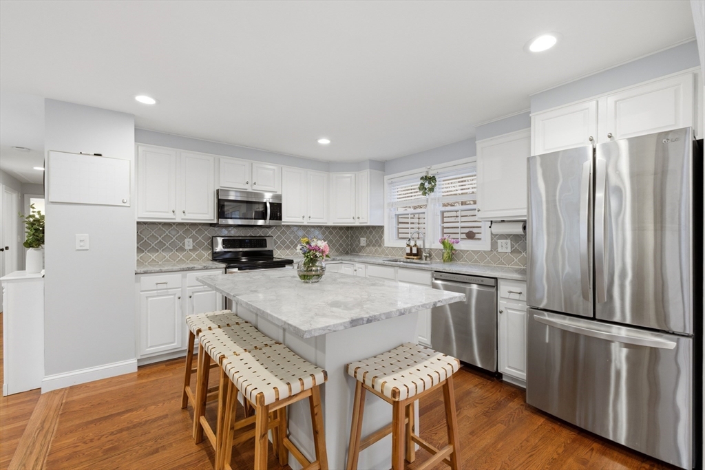 7 Paulette Drive Danvers, MA 01923 - Photo 7 of 25 a kitchen with stainless steel appliances a refrigerator stove microwave and cabinets