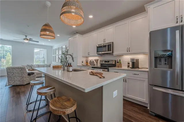 a kitchen with stainless steel appliances granite countertop a sink and stove top oven
