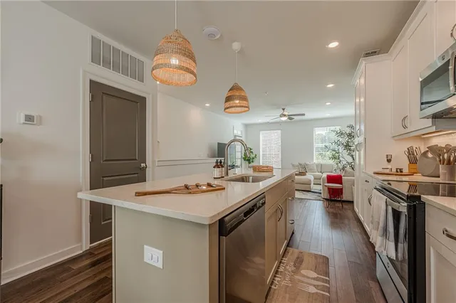 a kitchen with stainless steel appliances granite countertop a sink stove and refrigerator