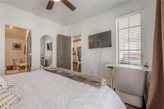 a bedroom with a bed and a television