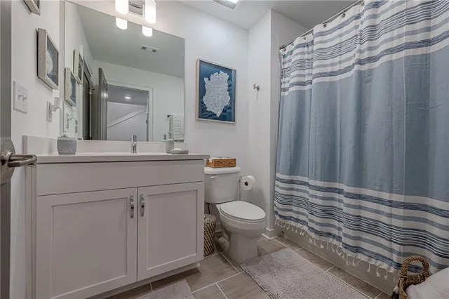 a en suite bathroom with a sink a toilet and a mirror
