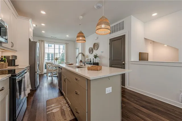 a kitchen with a sink cabinets and refrigerator