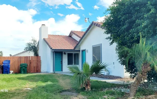 a view of a house with a yard and plants