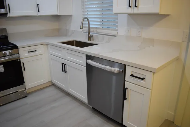 a kitchen with a sink and cabinets