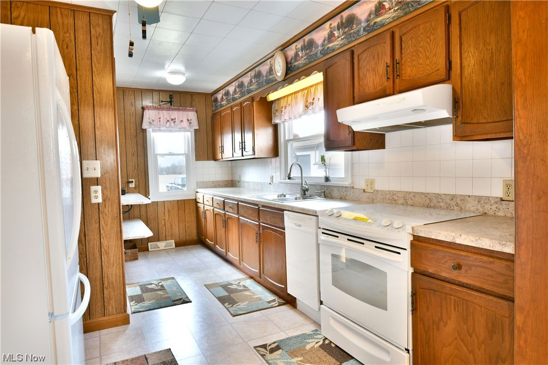 2713 Ridge Road Cortland, OH 44410 - Photo 11 of 35 Kitchen featuring white appliances, sink, and light tile floors