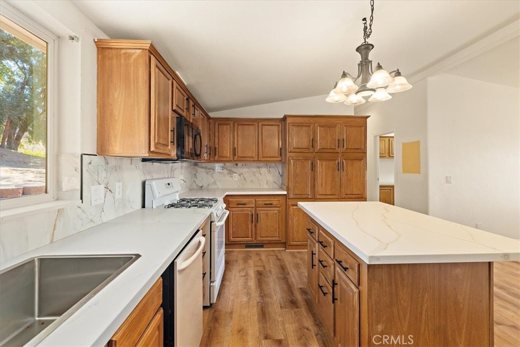 42557 Gibbel Road Hemet, CA 92544 - Photo 11 of 39 a kitchen that has a sink a stove and a table