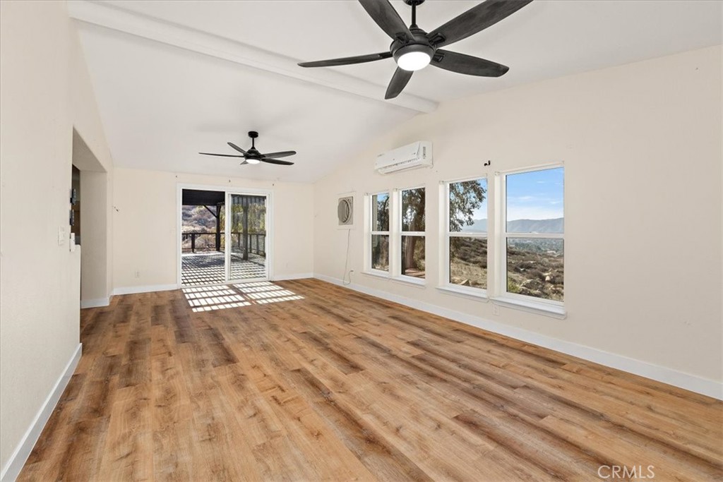 42557 Gibbel Road Hemet, CA 92544 - Photo 14 of 39 a view of an empty room with a window and wooden floor