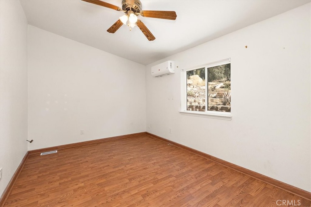 42557 Gibbel Road Hemet, CA 92544 - Photo 23 of 39 an empty room with windows and fan