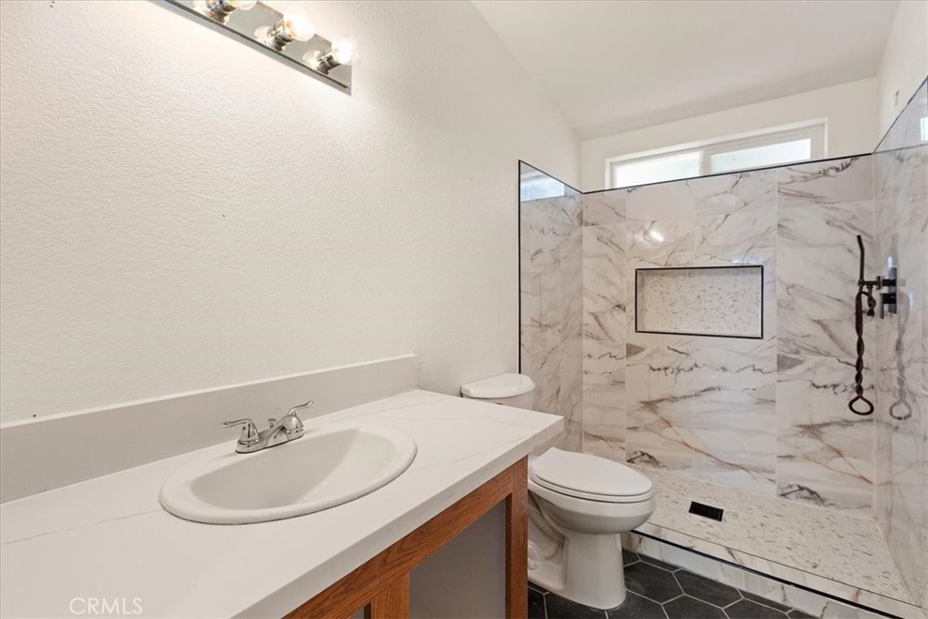 42557 Gibbel Road Hemet, CA 92544 - Photo 28 of 39 a bathroom with a sink toilet and shower