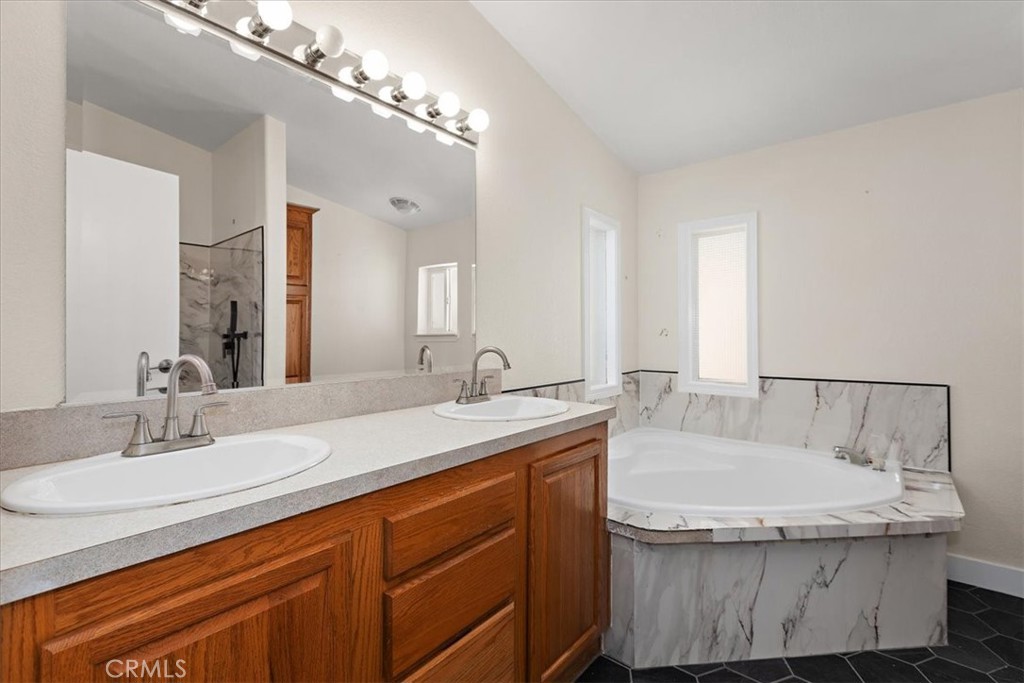 42557 Gibbel Road Hemet, CA 92544 - Photo 29 of 39 a bathroom with a granite countertop sink and a mirror