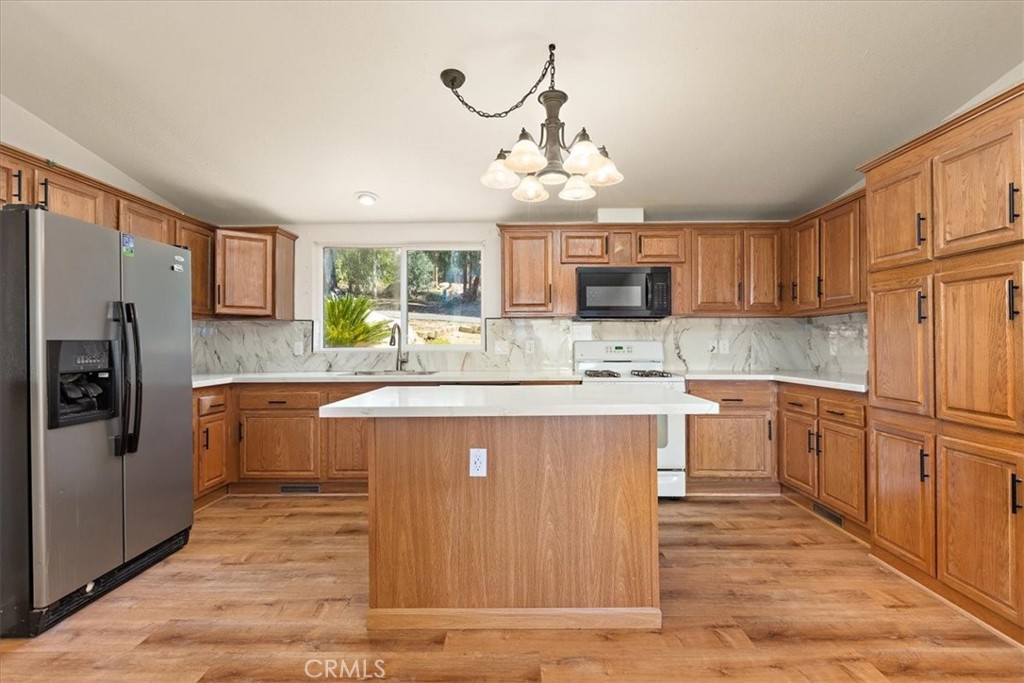42557 Gibbel Road Hemet, CA 92544 - Photo 8 of 39 a kitchen with stainless steel appliances granite countertop a refrigerator a stove top oven a sink and dishwasher