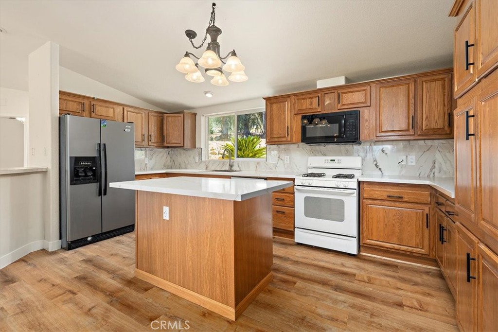 42557 Gibbel Road Hemet, CA 92544 - Photo 10 of 39 a kitchen with kitchen island granite countertop stainless steel appliances cabinets a sink and a counter top space