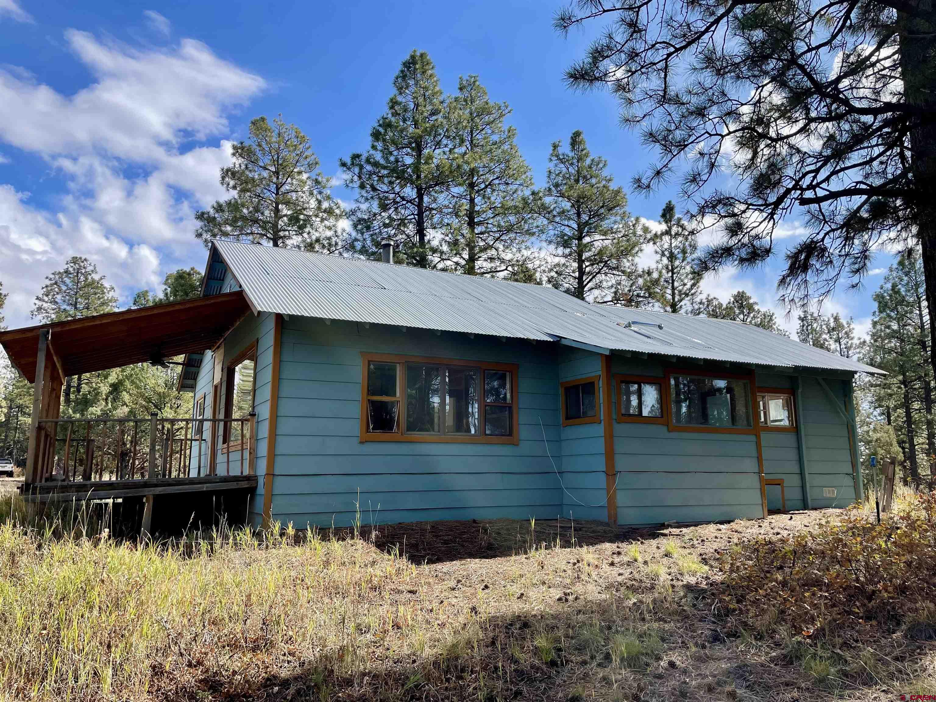 307 Deer Trail Road Durango, CO 81303 - Photo 4 of 16 a front view of a house with a yard covered with snow in front of it