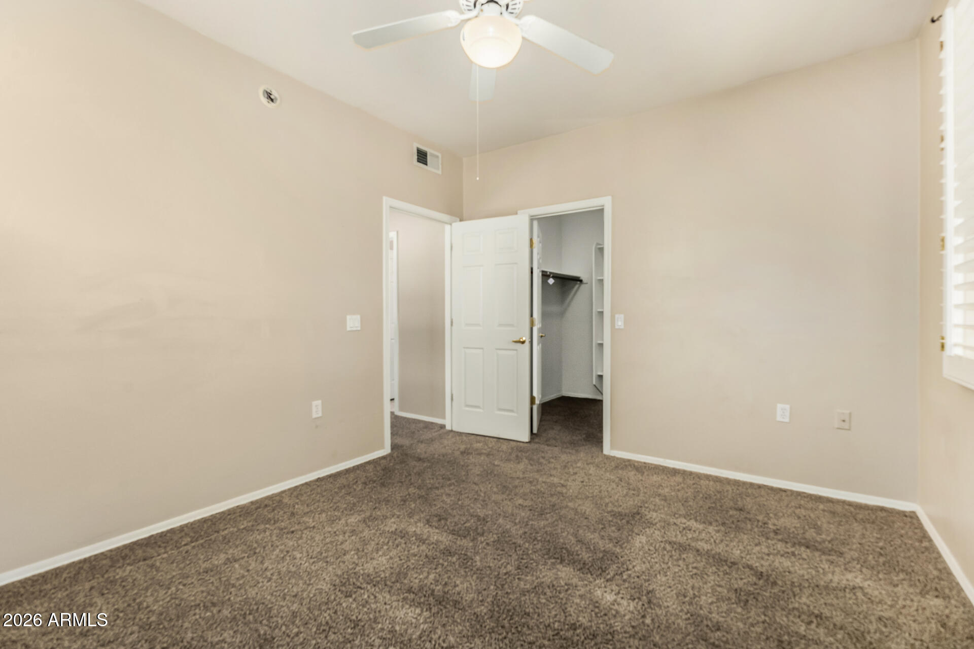 1445 East Broadway Road, Unit 116 Tempe, AZ 85282 - Photo 17 of 36 an empty room with a ceiling fan and bathroom view