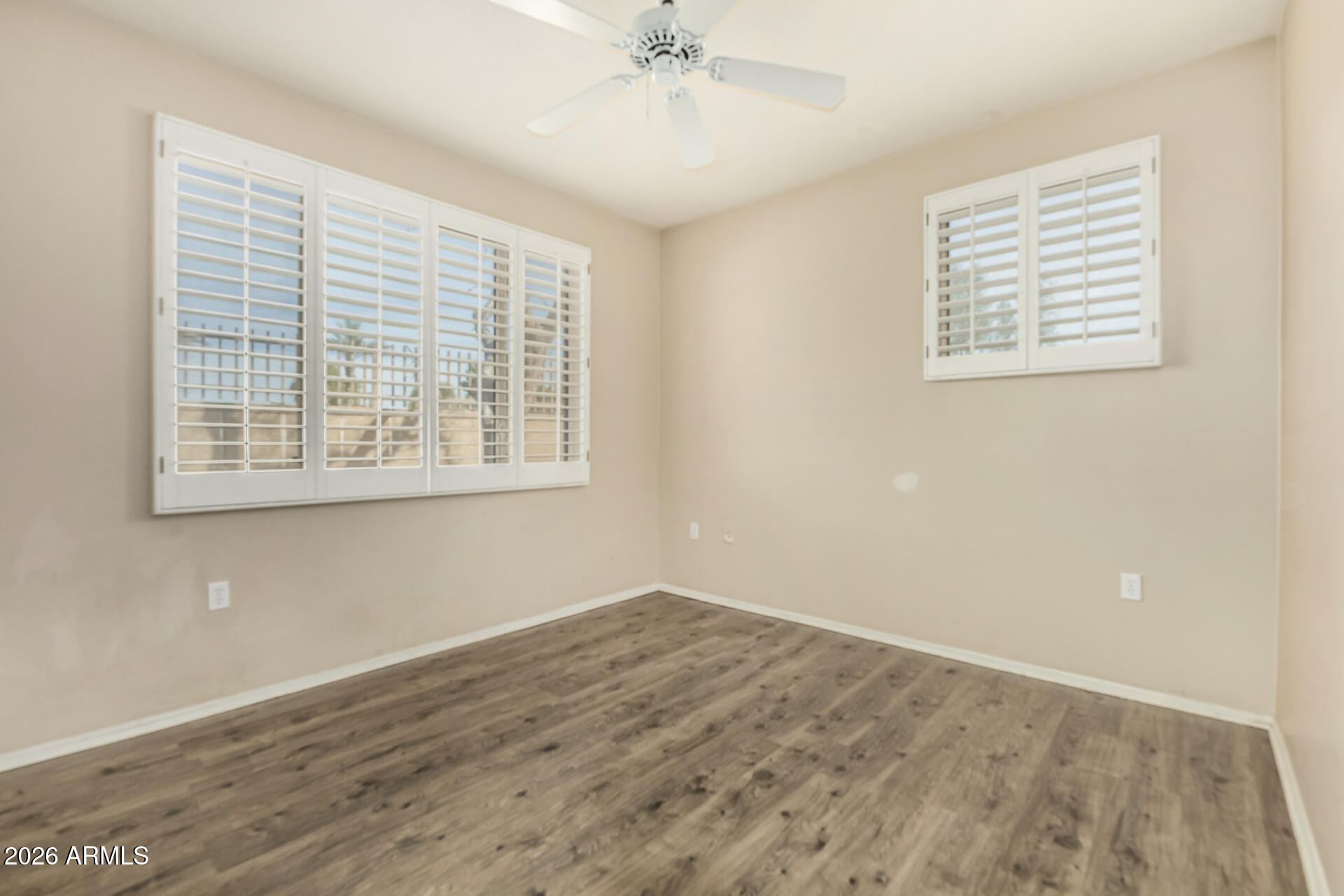 1445 East Broadway Road, Unit 116 Tempe, AZ 85282 - Photo 22 of 36 a view of an empty room with wooden floor and a window