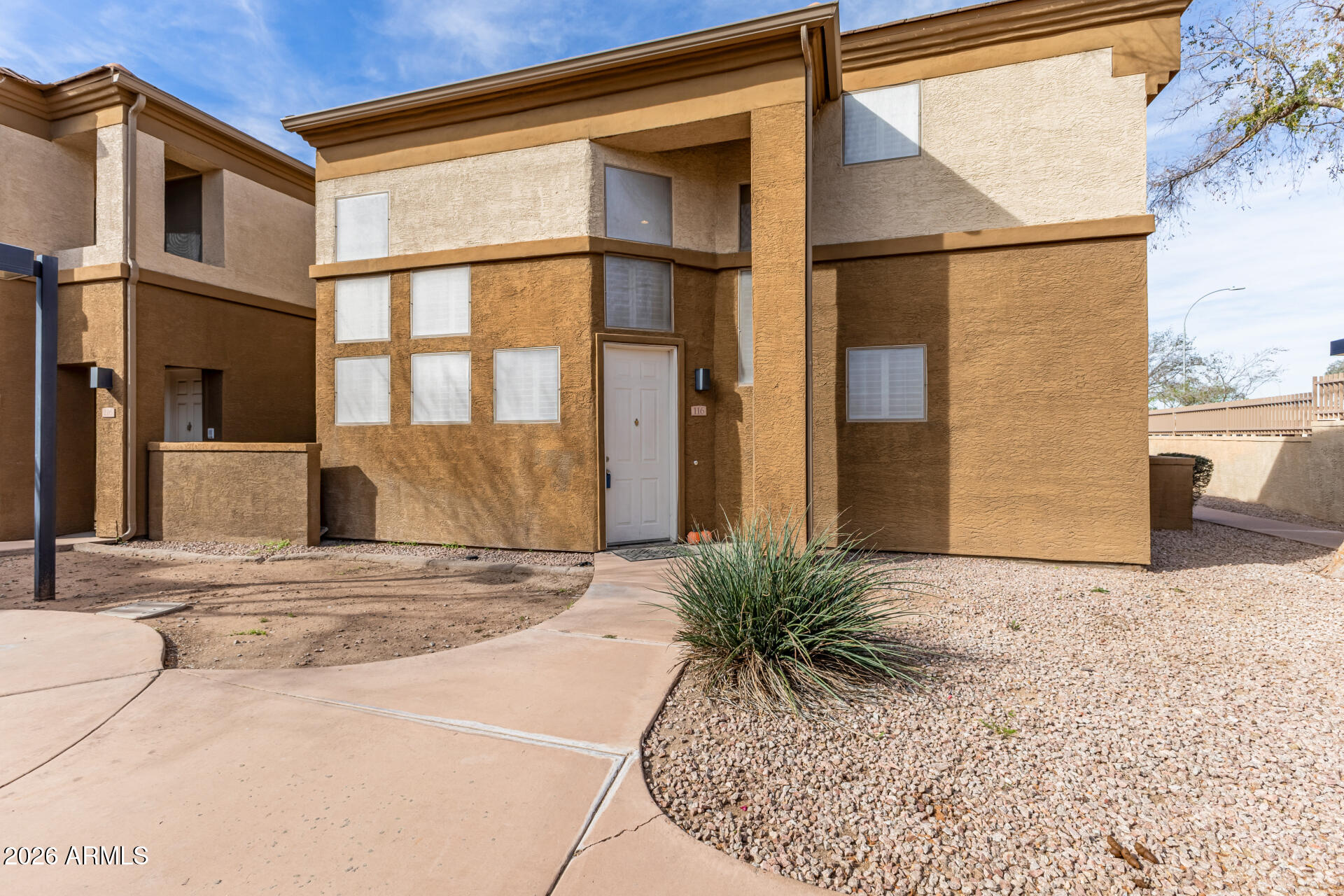 1445 East Broadway Road, Unit 116 Tempe, AZ 85282 - Photo 6 of 36 a front view of a house with a yard
