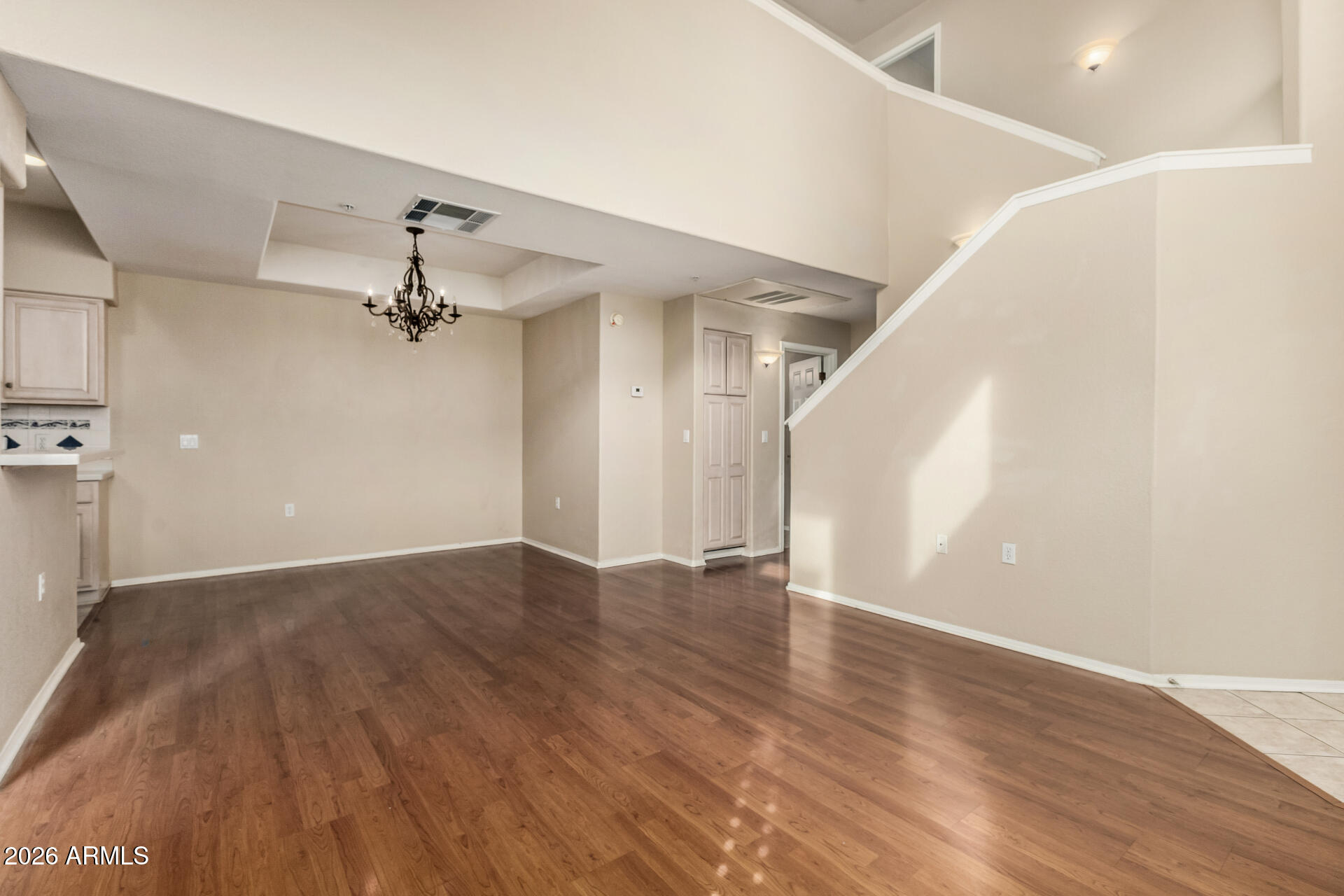 1445 East Broadway Road, Unit 116 Tempe, AZ 85282 - Photo 9 of 36 a view of an empty room with a window and wooden floor