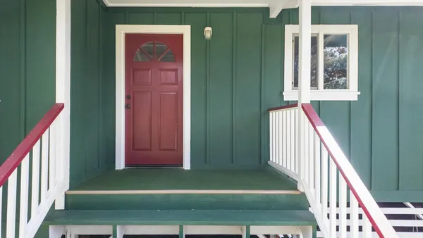 a view of a front door of the house and wooden floor