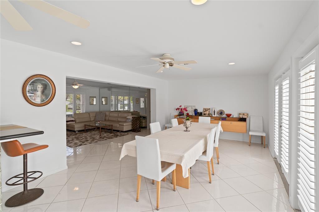 2670 Northeast 47th Street Lighthouse Point, FL 33064 - Photo 6 of 12 a view of a dining room with furniture and a large window
