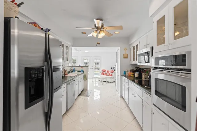 a bathroom with a granite countertop sink mirror vanity and toilet