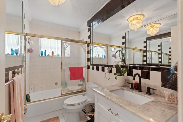 a large white kitchen with a large window and furniture