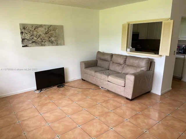a living room with couches and a flat screen tv