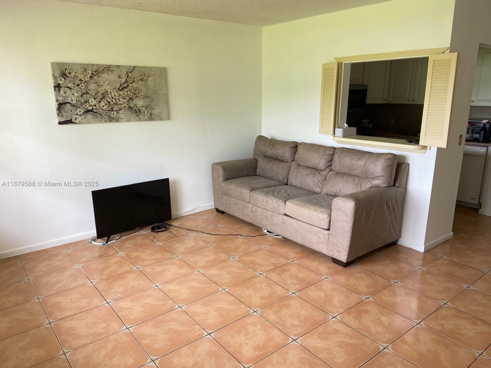 a living room with couches and a flat screen tv