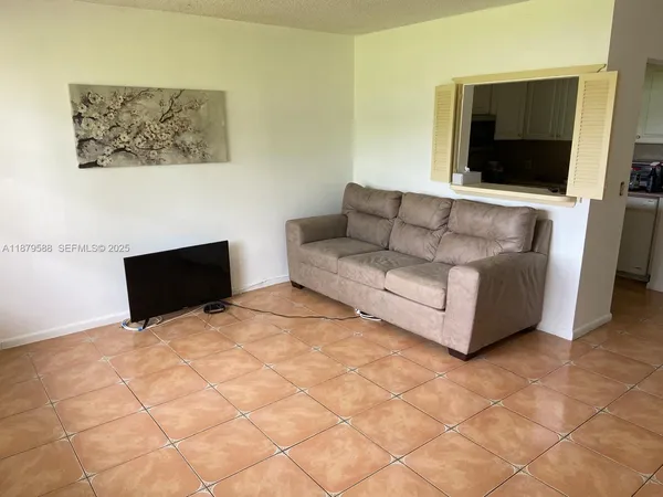 a living room with couches and a flat screen tv