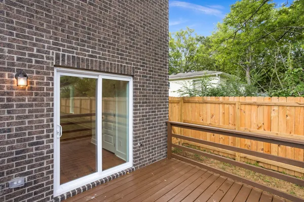 a view of a wooden door and a floor to ceiling window