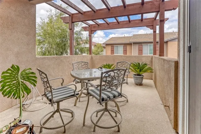 a view of a patio with table and chairs and potted plants with wooden floor