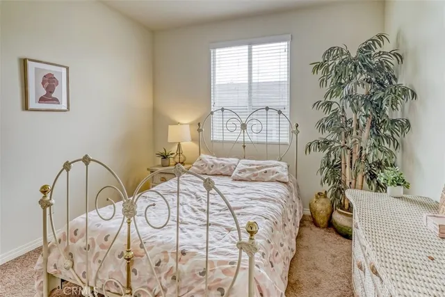 a bedroom with a bed and a potted plant