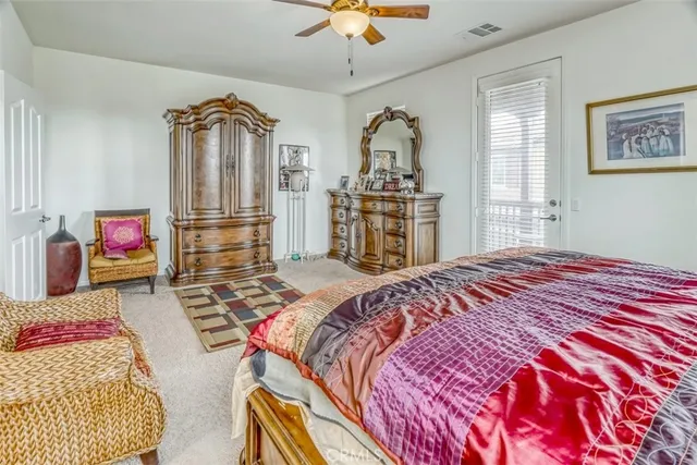 a bedroom with a bed dresser and window
