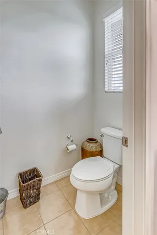 a white toilet sitting next to a bathroom sink