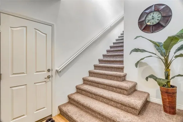 a view of entryway with stairs and wooden floor