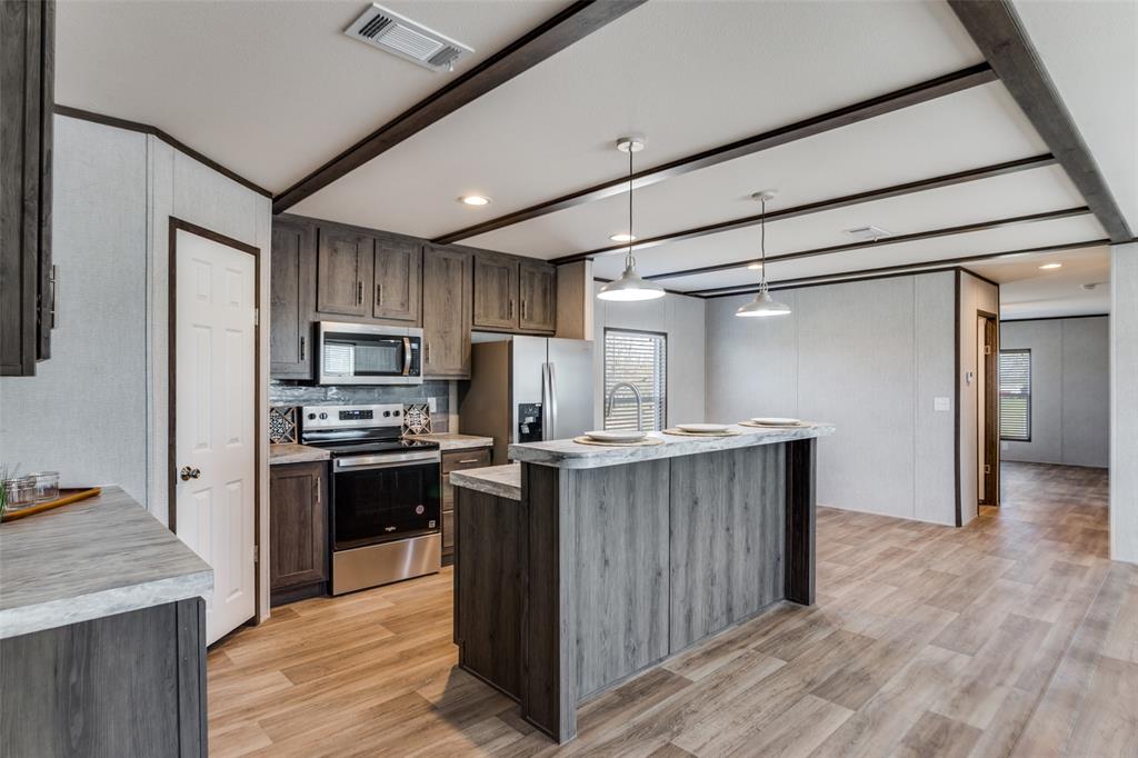 175 Cedar Drive Azle, TX 76020 - Photo 10 of 25 a kitchen with cabinets and stainless steel appliances